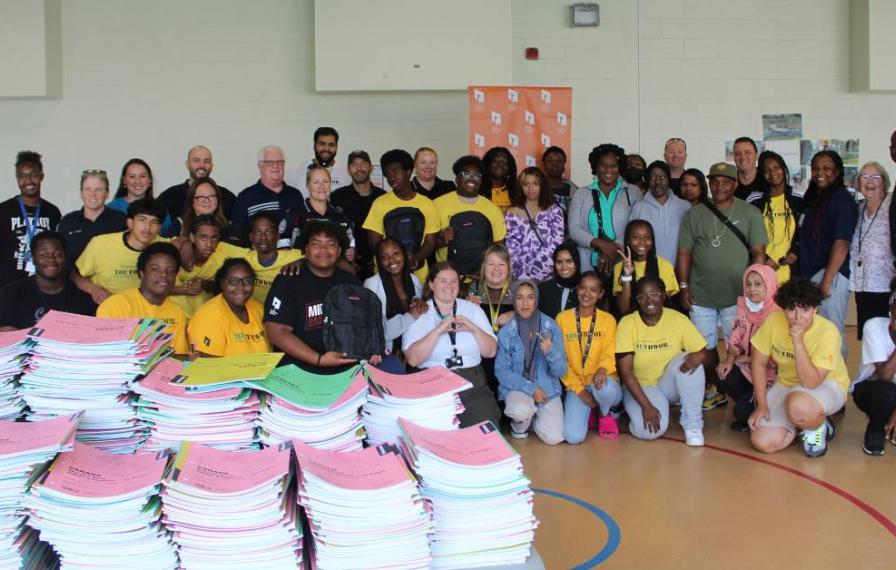 TCHC staff who helped pack backpacks and school supplies for TCHC communities stand together for a group shot.