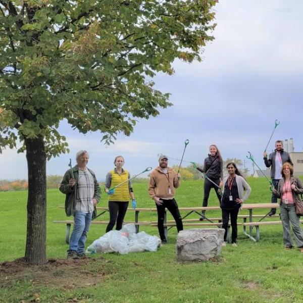 Conservation team members in a park holding litter pickers