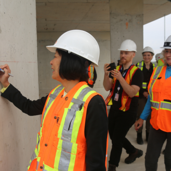 Mayor Olivia Chow signing the wall at Don Summerville "topping off" event