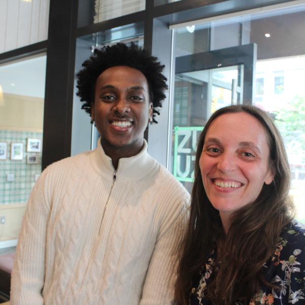 A young man and woman smiling at a camera. 