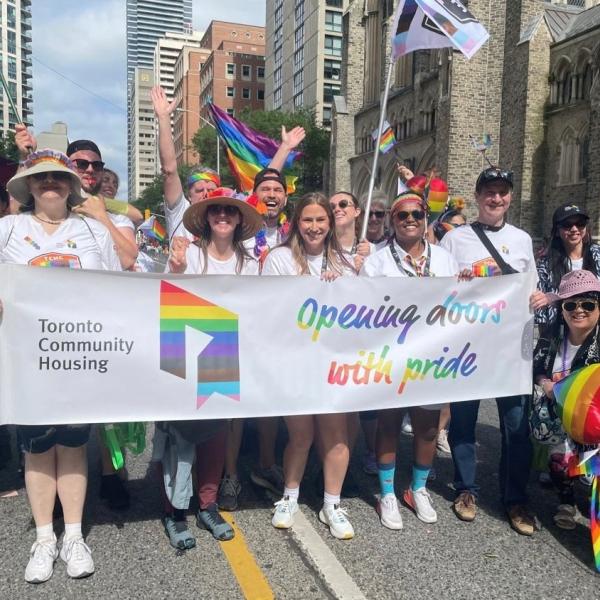 TCHC employees holding signs and banners during the Pride Parade march
