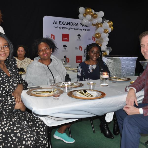 Sean Baird, President and CEO of TCHC chats with Alexandra Park residents at the 2024 scholarship awards dinner. 