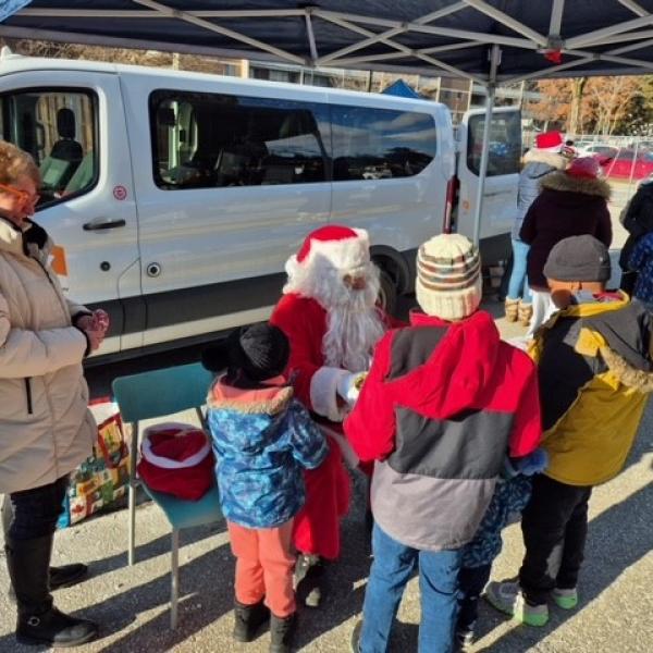 Kids in TCHC communities receiving gifts from Santa