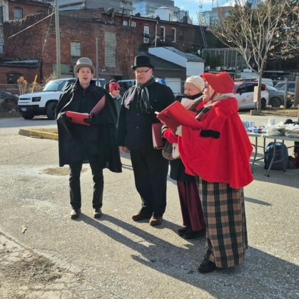 People singing carols in the holiday spirit.