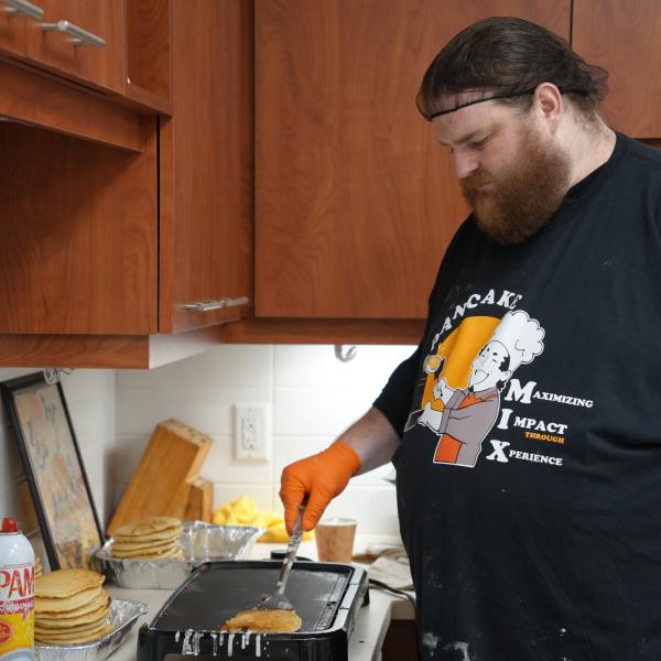 Food service worker making pancakes