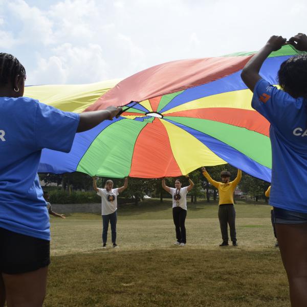 Children holding a parachute 
