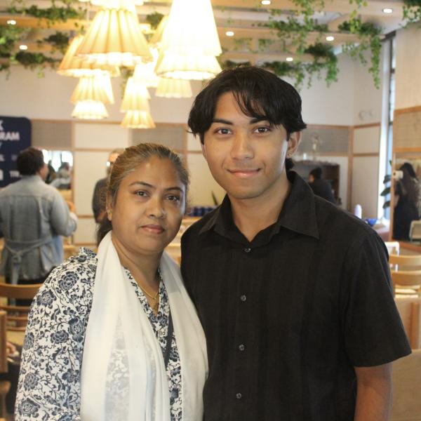 A photo of a man and woman posing for the camera. 