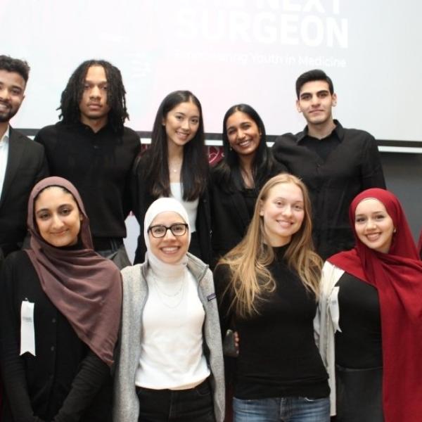 A group of people standing in two rows posing for a photo