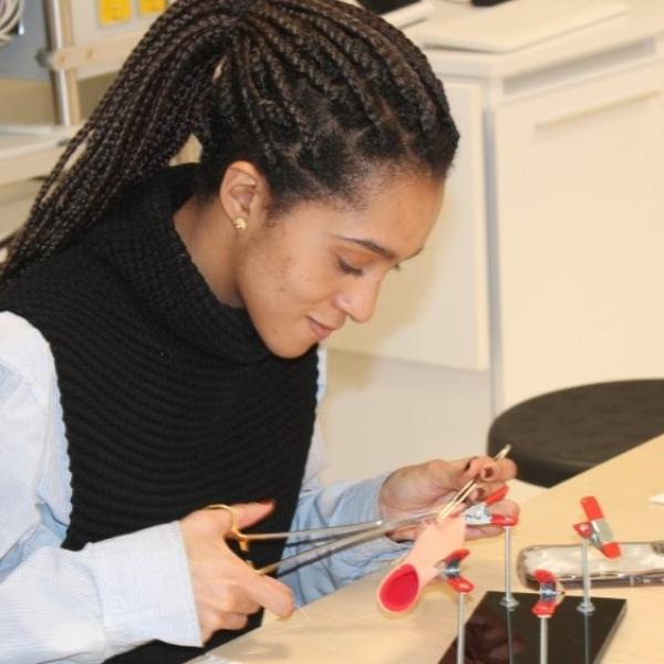 A person using tools in a lab.