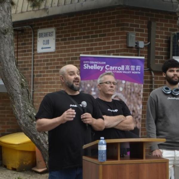 A group of people standing in front of a podium
