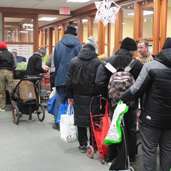 Visitors line up for various food items 