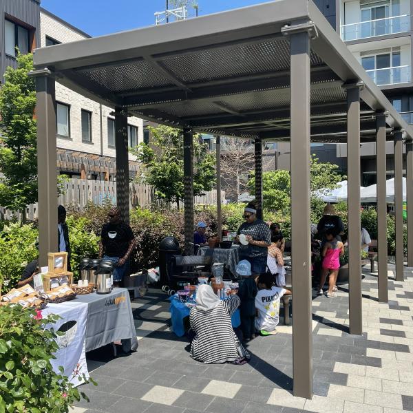 marketplace tables under a pergola at an outdoor market