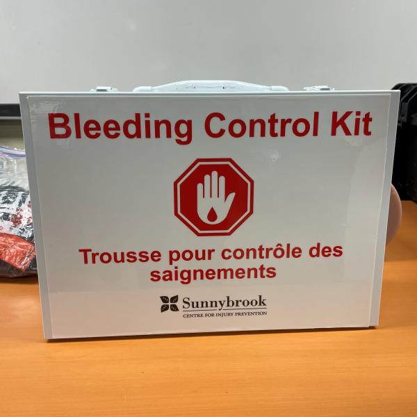 A white box on a desk that says "Bleeding Control Kit" in red letters.