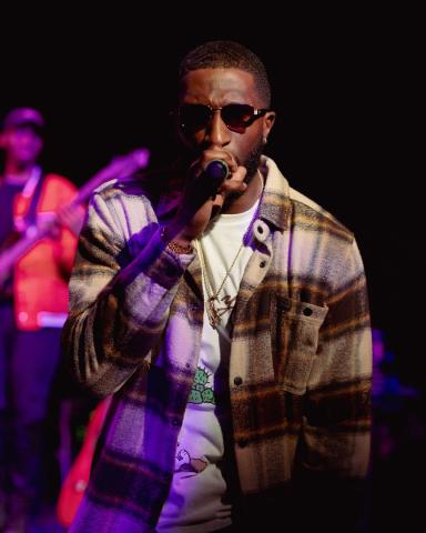 A male performing on stage.
