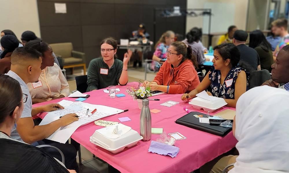 The Regent Park Community benefits oversight working group sits at a table discussing issues that matter to their community