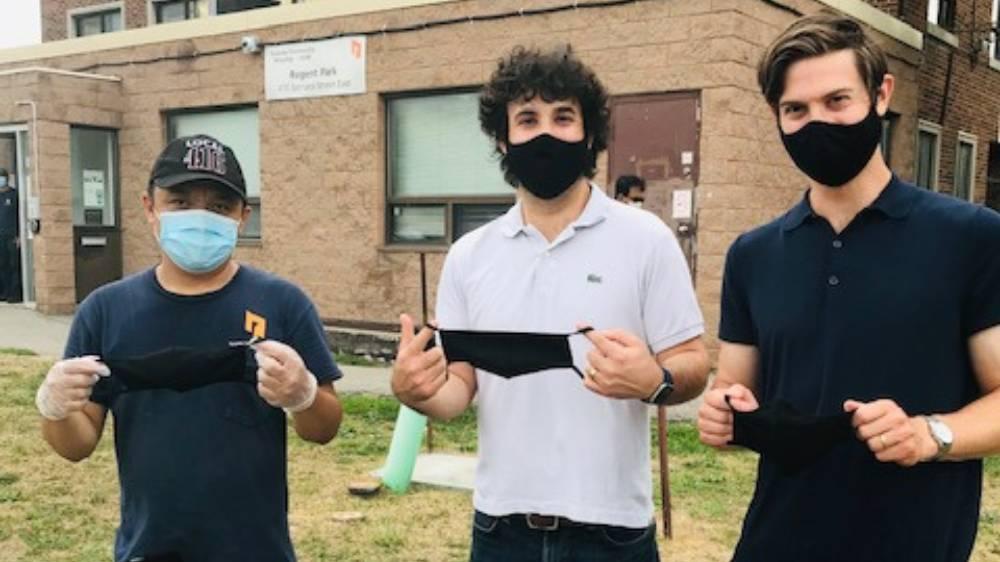 TCHC's Romil Ramales (left) and Well Grounded Real Estate's Gabriel Diamond (centre) and Jonathan Diamond display samples of the cloth masks that the company donated to TCHC tenants. 