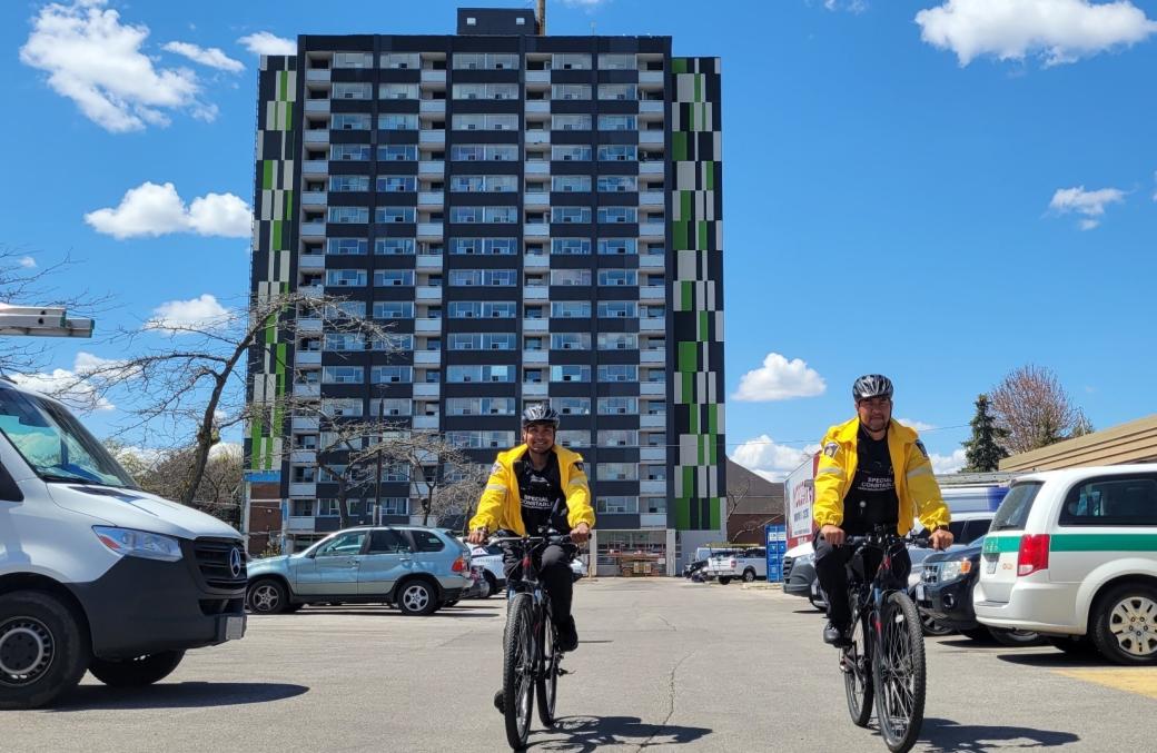 two CSU officers riding bikes outside 415 Driftwood Avenue