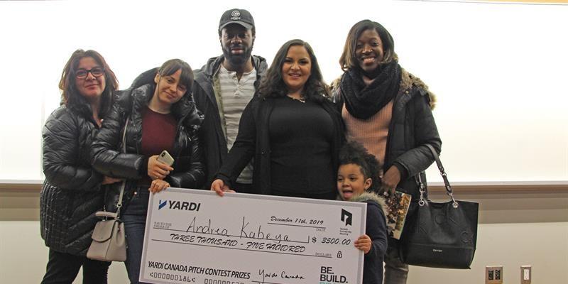 tenants pose with a giant cheque