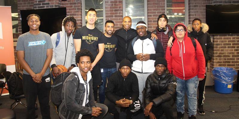 Group photo of tenant youth and staff in front of a building