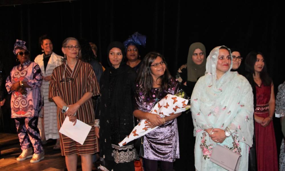 A group watches the Regent Park "Sewing the Climate" fashion show