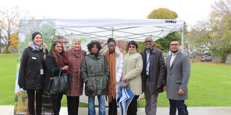 Group photo of staff and tenants outside in the park