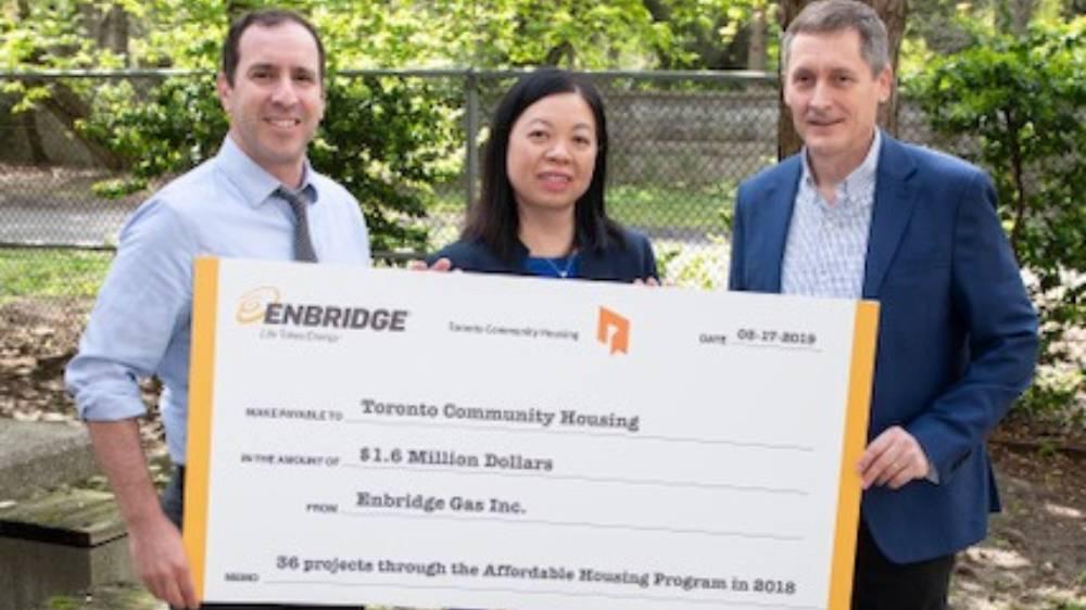 Ward 12 Councillor Josh Matlow, Rose-Ann Lee, Chief Financial Officer of Toronto Community Housing, and Jim Sanders, Senior Vice President, Enbridge Gas, during Enbridge's $1.6 million incentive cheque presentation to Toronto Community Housing for the completion of 36 energy efficiency projects at buildings across Toronto in 2018.