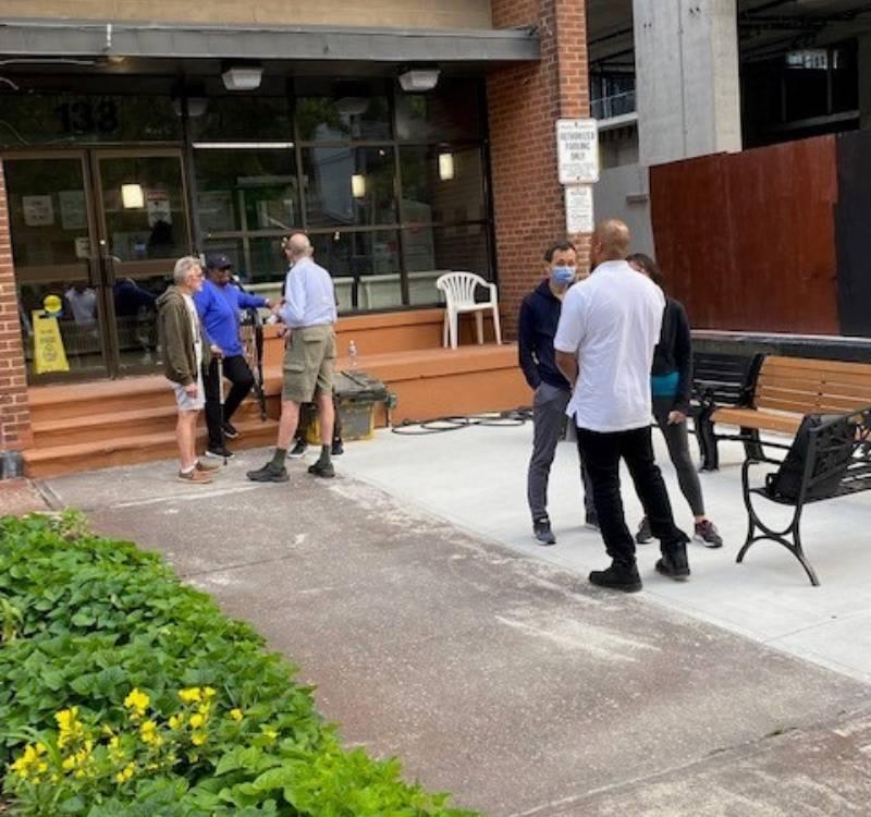 Residents and TCHC staff discussing the new outdoor gathering space in front of 133 Broadway Avenue