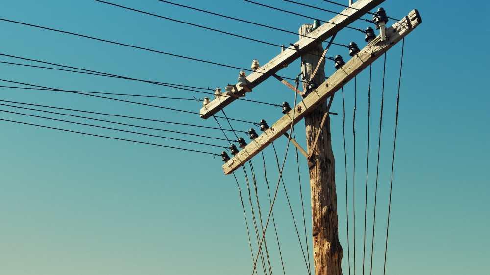 A set of power lines, showing how when the temperatures rise, the risk of power outages increases A set of power lines