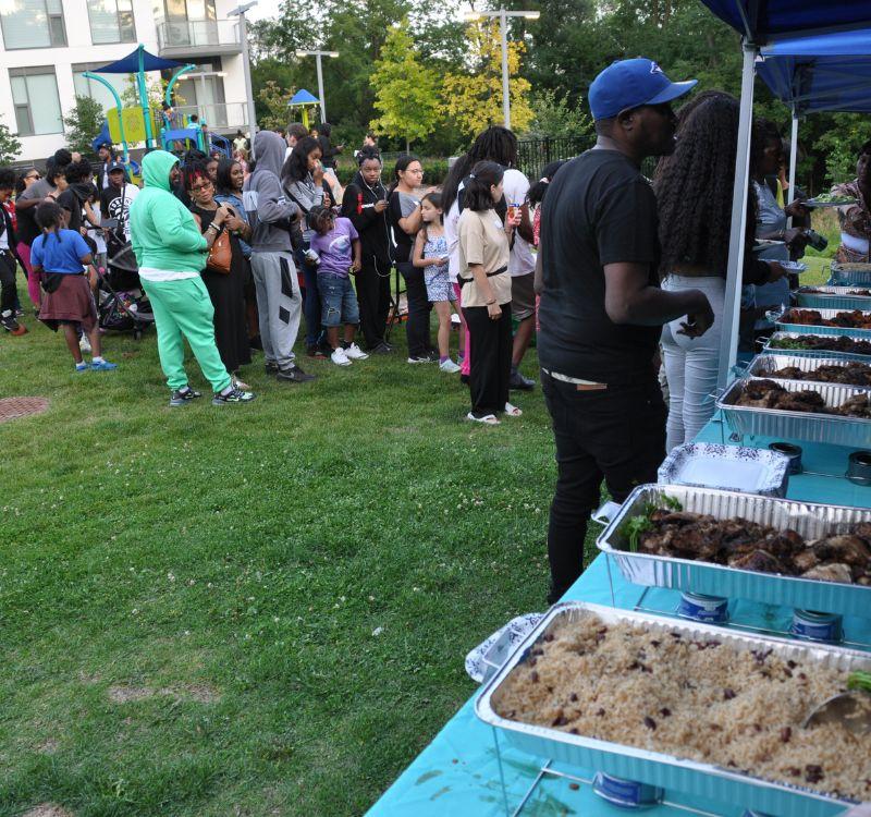 Community members lining up to get food at Leslie Nymark's celebration event.