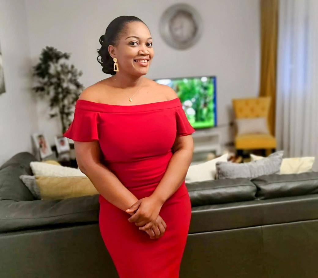 Woman posing in a red dress and smiling