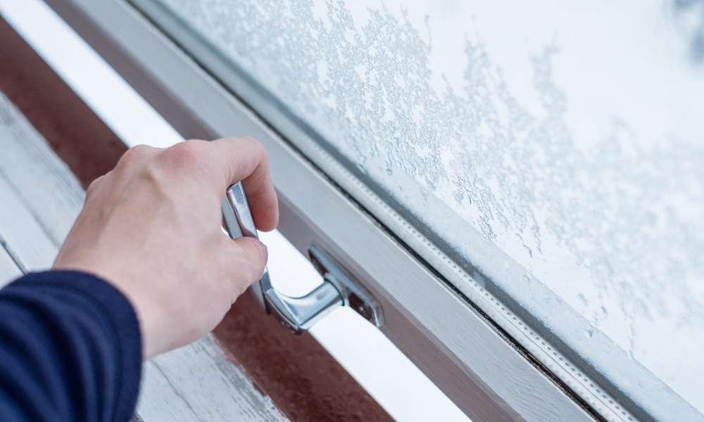 A hand opening lock window with ice flake. 