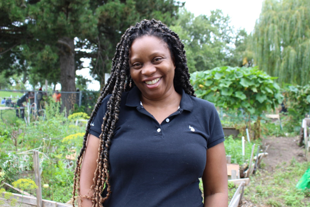 Woman posing in a garden outdoors and smiling