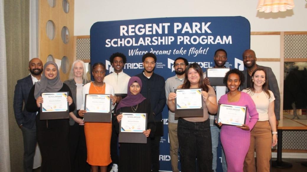 A group of people holding certificates while smiling for a camera.