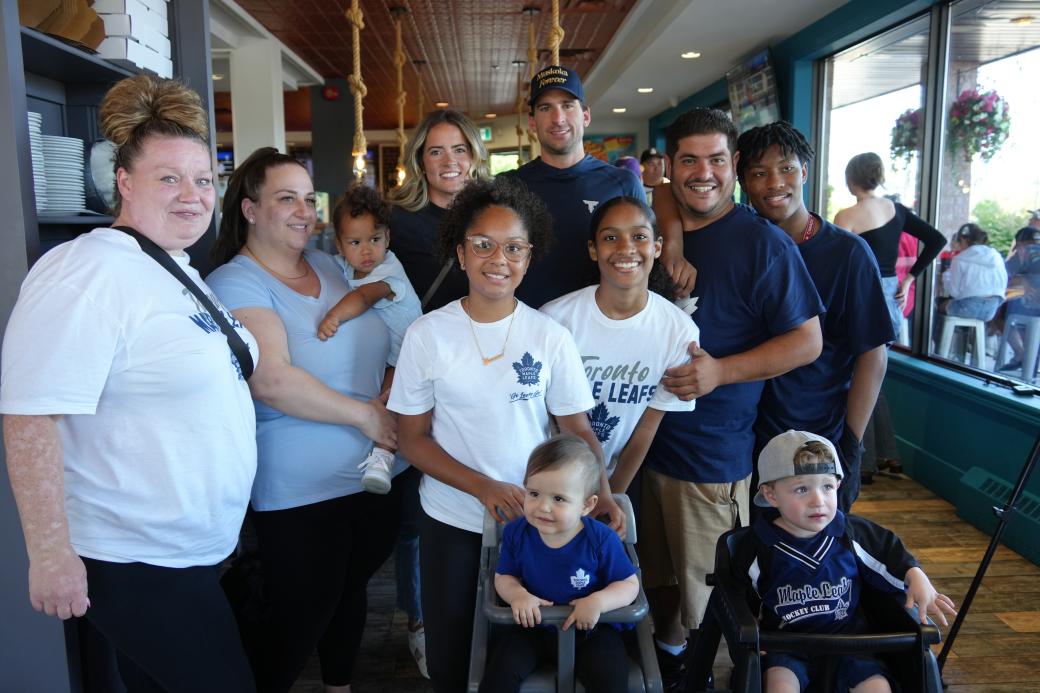 Two families from the San Antonio Way community pose for photos with John and Aryne Tavares.