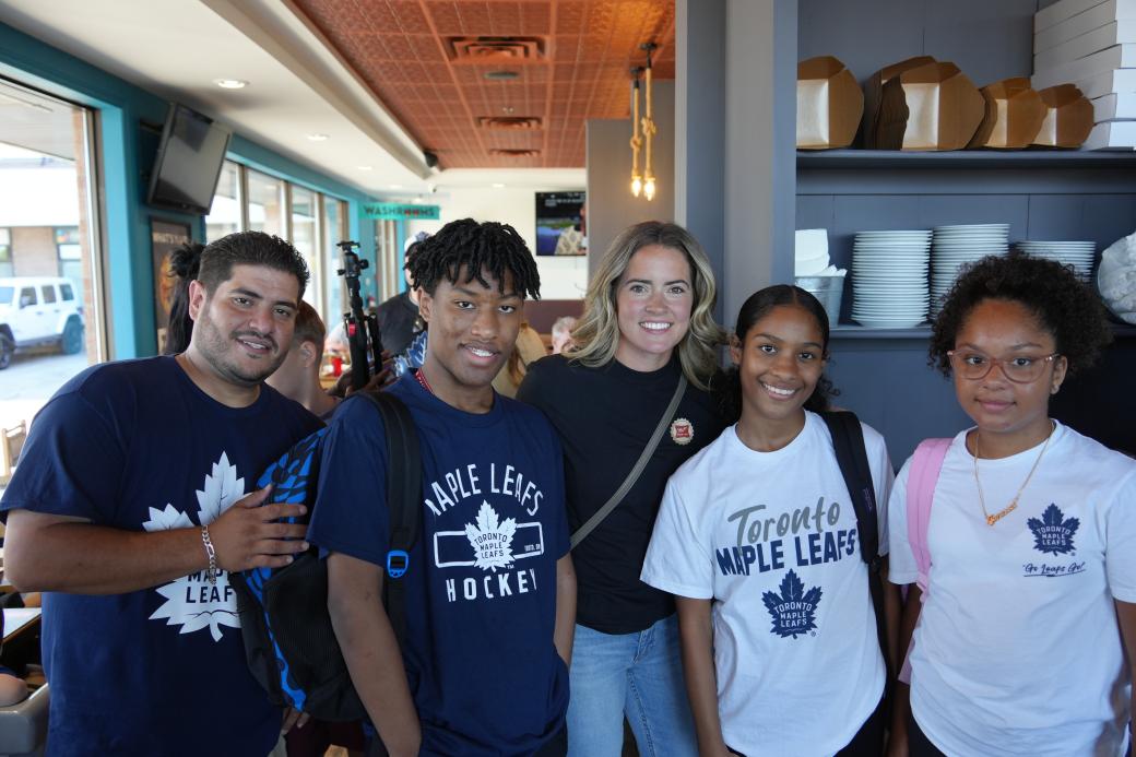 Aryne Tavares (centre) with TCHC tenants at Pie Wood Fired Pizza Joint in Barrie, ON, on Wednesday, August 7, 2024.