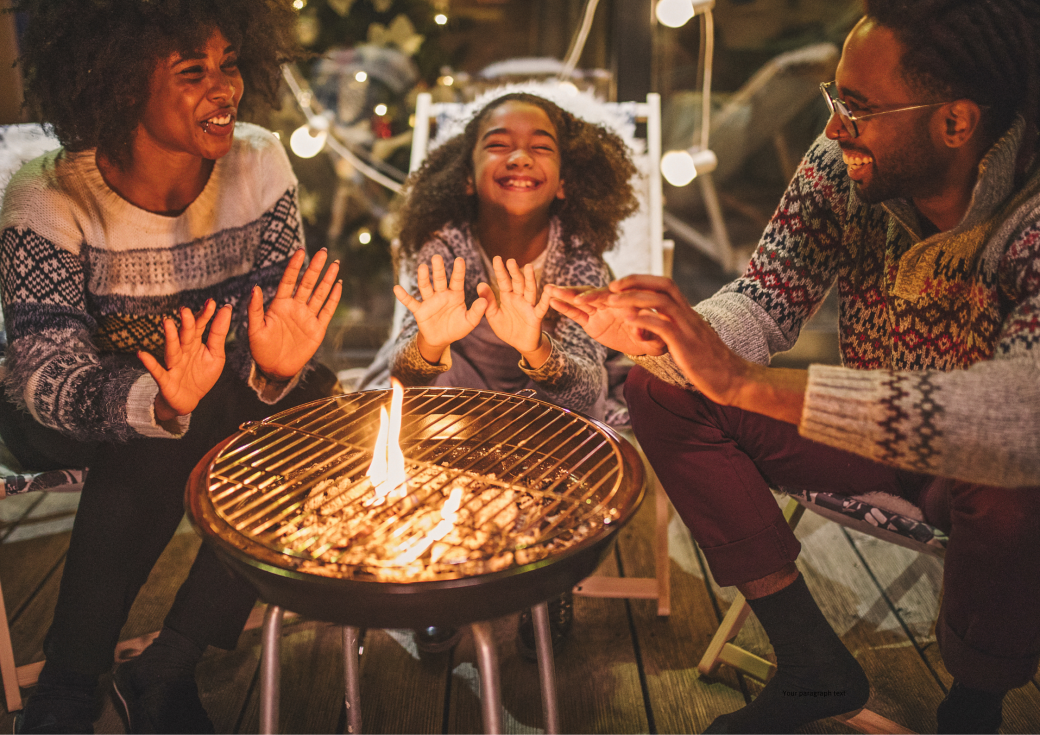 A family warming their hands near a fire pit A family warming their hands near a fire pit