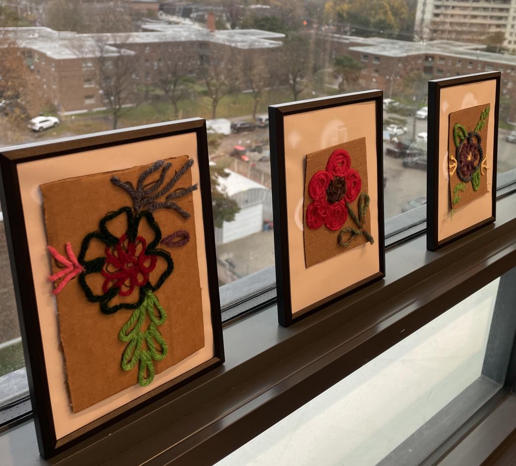 A row of framed pictures on a window sill