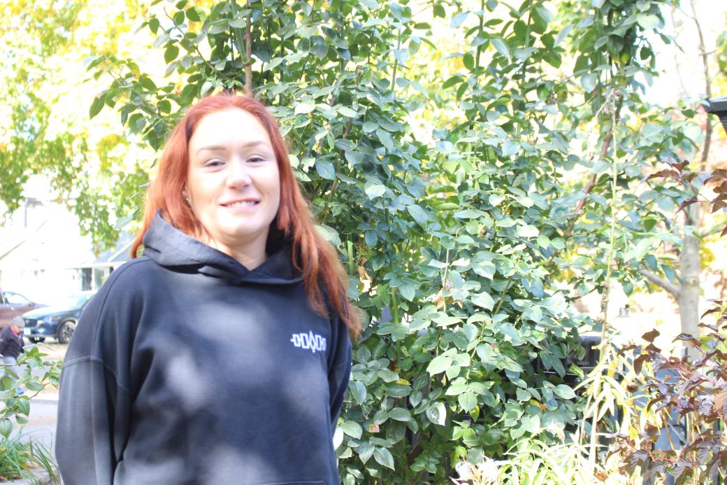 Amanda Brown posing next to a large bush Amanda Brown posing next to a large bush