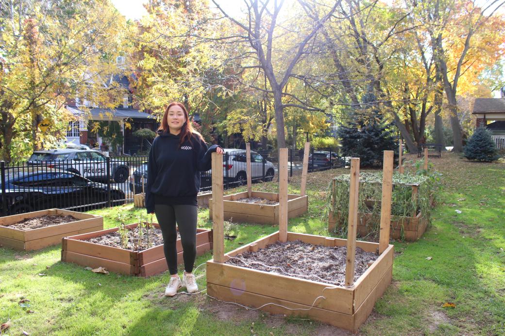 Amanda Brown posing outdoors in a community garden Amanda Brown posing outdoors in a community garden