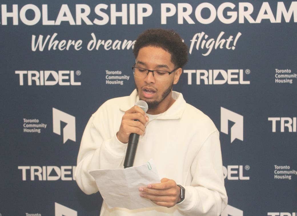 A photo of Adam Elmi giving a speech. 