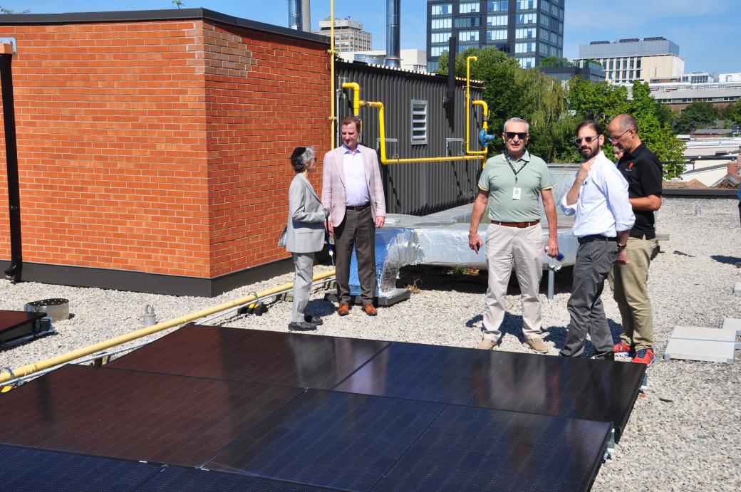 Councillor Dianne Saxe with TCHC staff on a rooftop looking at solar panels