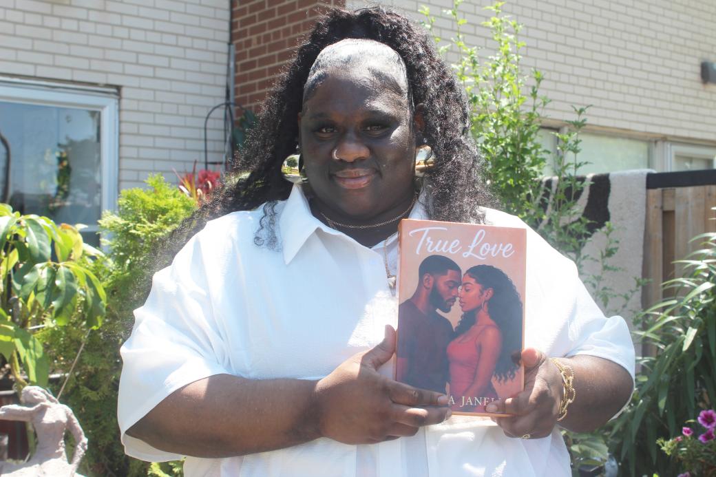 Chanta Alliman outside holding her book True Love