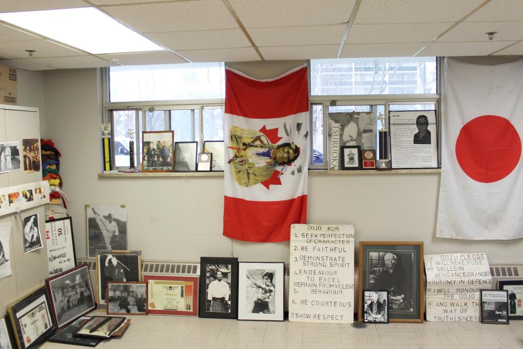 A basment karate dojo, with flags and memorabilia on the walls