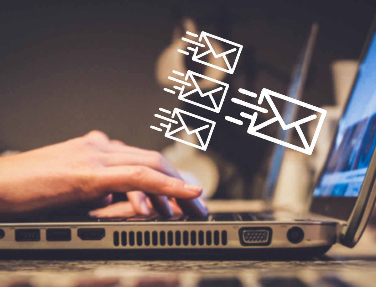 person typing on laptop, email icons