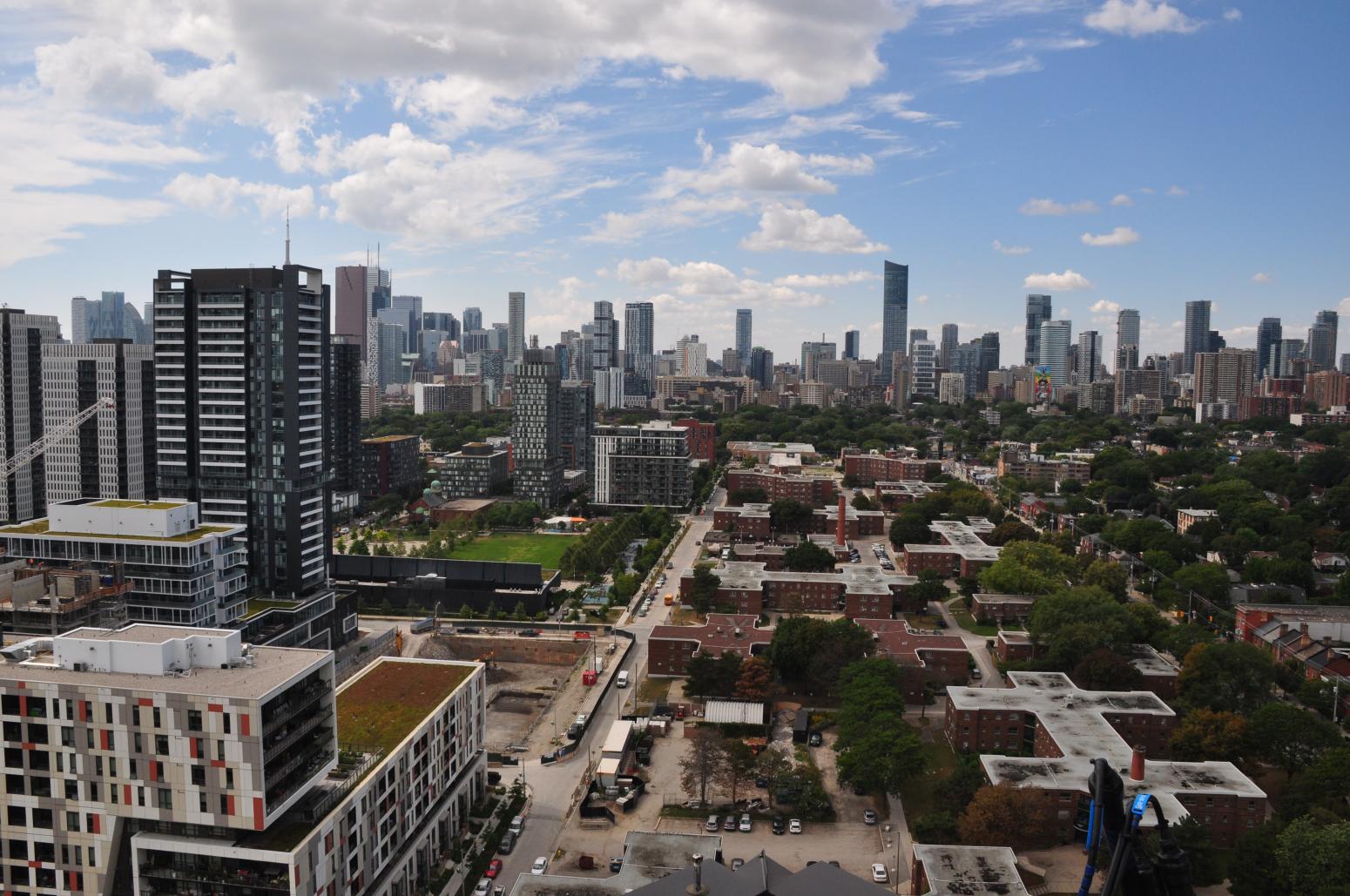 Aerial view of Regent Park buildings on a sunny day, with more high-rise buildings in the background.