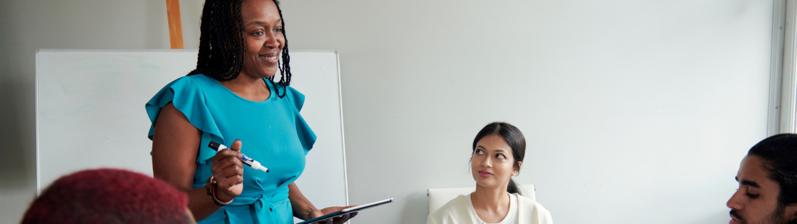 A person standing up in a room to speak
