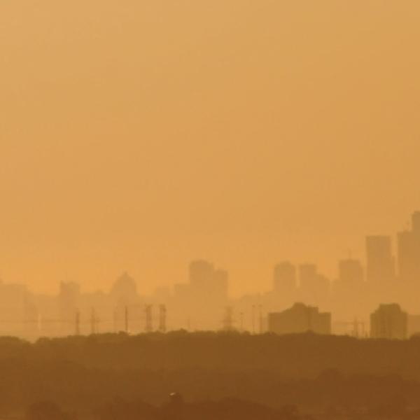 Hazy Toronto skyline, the horizon appears orange and the buildings in the distance are unclear due to smog