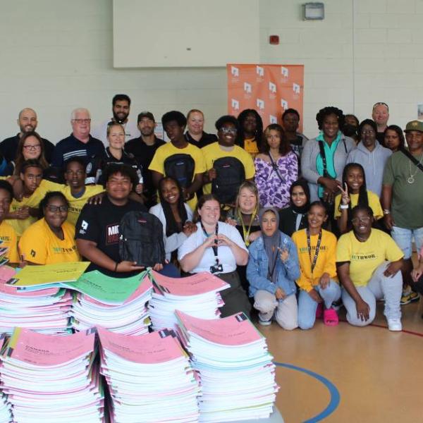 TCHC staff who helped pack backpacks and school supplies for TCHC communities stand together for a group shot.