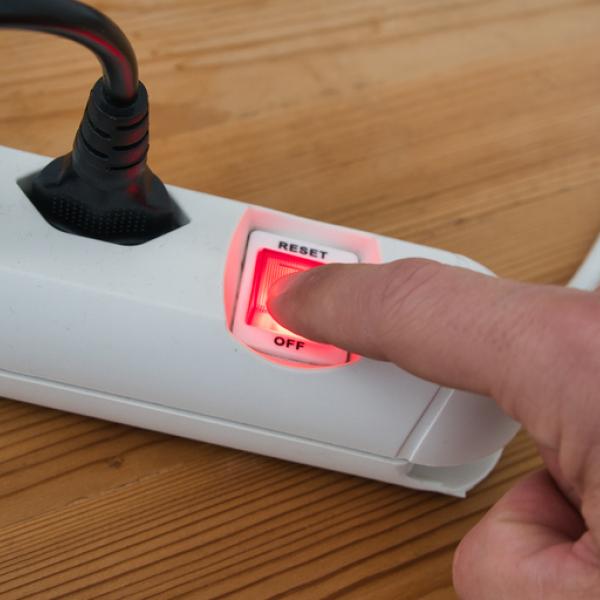 a power bar with someone hitting the on/off button